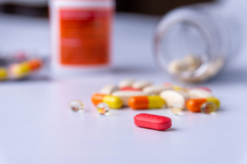 Colorful pills and capsules on a white background copy space
