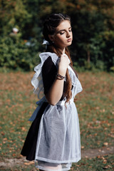 Girl long healthy shiny hair. Perfect tied hair in ponytails. Cute girl in school uniform. Girl...