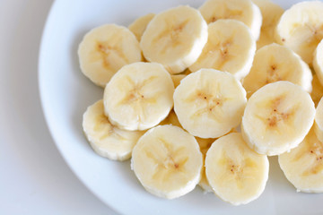 Banana slices on a white plate.