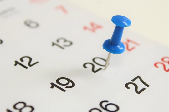 Blue pin on calendar.
