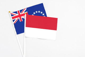 Monaco and Cook Islands stick flags on white background. High quality fabric, miniature national flag. Peaceful global concept.White floor for copy space.