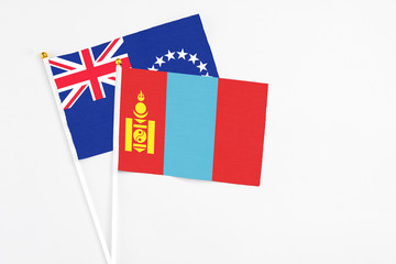 Mongolia and Cook Islands stick flags on white background. High quality fabric, miniature national flag. Peaceful global concept.White floor for copy space.