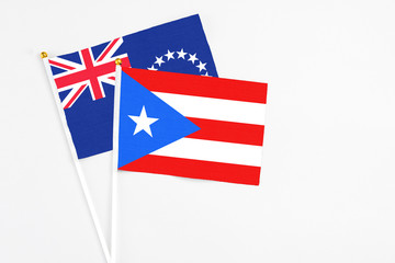 Puerto Rico and Cook Islands stick flags on white background. High quality fabric, miniature national flag. Peaceful global concept.White floor for copy space.