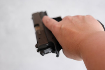 law enforcement aim pistol by the hand in academy shooting range in flare. a pistol 9mm, in the hands of women,