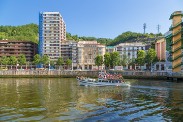 Fototapeta na wymiar Bilbao, Spain. Tourist boat on the river Nervión