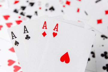 Aces in hand. Playing cards on a green background. From above. Place for text