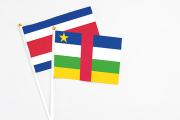 Central African Republic and Costa Rica stick flags on white background. High quality fabric, miniature national flag. Peaceful global concept.White floor for copy space.