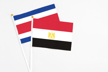 Egypt and Costa Rica stick flags on white background. High quality fabric, miniature national flag. Peaceful global concept.White floor for copy space.