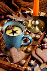 Cup of tea, apple, spices, nuts and  cookies