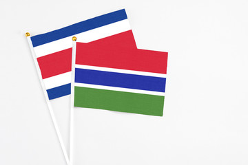 Gambia and Costa Rica stick flags on white background. High quality fabric, miniature national flag. Peaceful global concept.White floor for copy space.