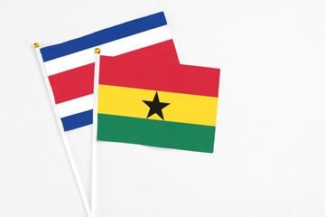 Ghana and Costa Rica stick flags on white background. High quality fabric, miniature national flag. Peaceful global concept.White floor for copy space.