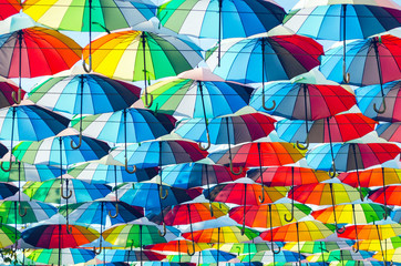 Hanging multicolored colorful umbrellas adorn the alley, street decoration