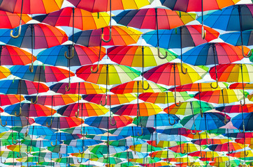 Hanging multicolored colorful umbrellas adorn the alley, street decoration