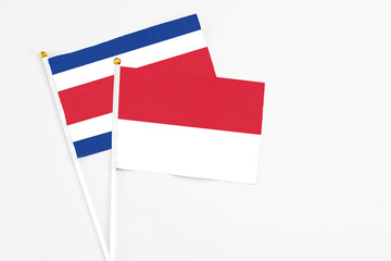 Indonesia and Costa Rica stick flags on white background. High quality fabric, miniature national flag. Peaceful global concept.White floor for copy space.