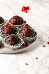 Chocolate muffins with zucchini. Muffins served with redcurrant.