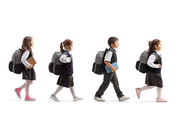 Schoolchildren in uniforms walking in line