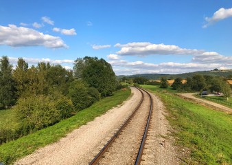 Fototapeta na wymiar Single railway track through countryside on a bright, sunny day