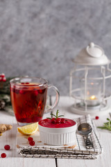 Fresh made cranberry sauce with cranberry tea. Cranberry jam with ginger and lemon.