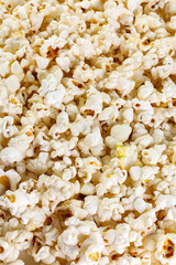 Heap of delicious popcorn, isolated on white background . Scattered popcorn texture background. Top view.