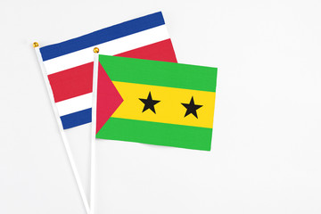 Sao Tome And Principe and Costa Rica stick flags on white background. High quality fabric, miniature national flag. Peaceful global concept.White floor for copy space.