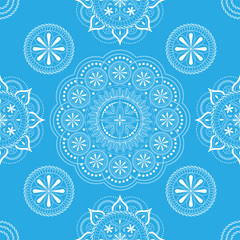 Seamless pattern with openwork floral ornament in pastel blue and white colors on a white background