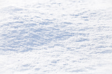 Obraz premium Background of sparkling fresh white snow texture with light blue sky reflection tone.