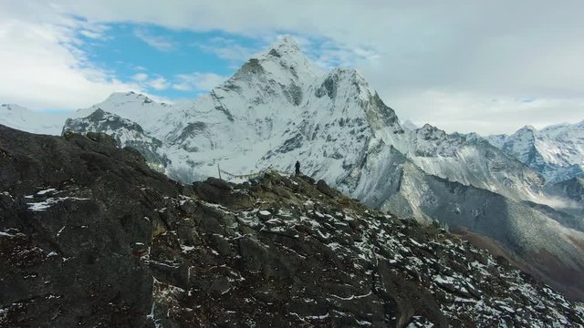 Hiker Man and Ama Dablam Mountain. Himalaya, Nepal. Aerial View. Drone is Orbiting