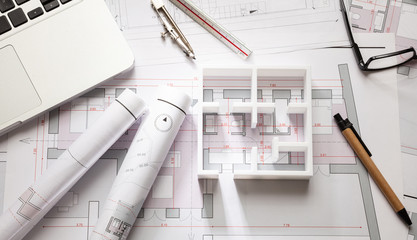 Construction concept. Residential building drawings and house model,
