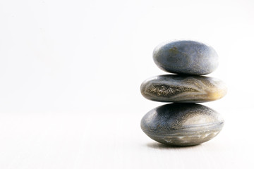 Naklejka na ściany i meble Pile of stones isolated on white background, Stones for massage and zen lifestyle. Mystic stones in balance.