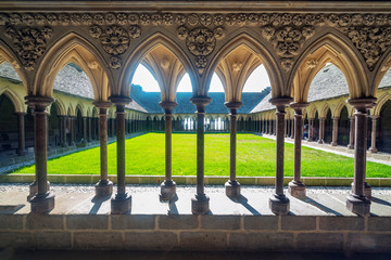 Cloister of the abbey of Mont Saint Michael formed by a succession of columns and arches.
