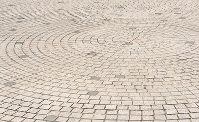 Circle stone tile floor design for footpath in center of urban park, street city exterior background