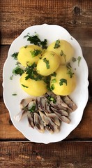 Delicious potatoes with dill and herring for dinner