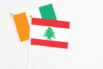 Lebanon and Cote D'Ivoire stick flags on white background. High quality fabric, miniature national...