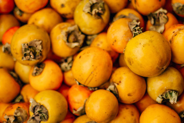  ripe tasty orange persimmon on the food market
