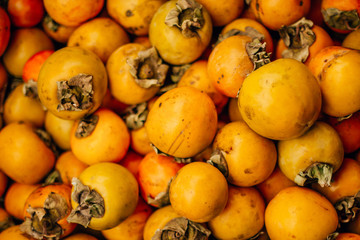  ripe tasty orange persimmon on the food market