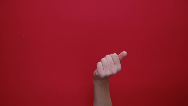 Woman hand making gesture Come closer on the background red paper. Body language concept. With place for text or image, promotional content. Advertising area, workspace mock up
