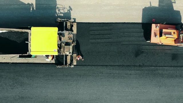 Bitum is getting placed onto the motorway by the workers