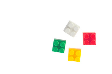  square bricks of the children's designer of red, green, yellow and white.Flat lay . copy space