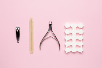 Manicure and pedicure tools on pink background, nail care set