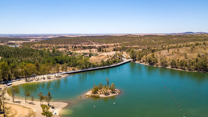Fototapeta na wymiar Amazing lake with cristal water surrounded by trees. Mina de S. Domingos, Mertola Alentejo Portugal. drone photo.