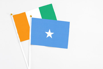 Somalia and Cote D'Ivoire stick flags on white background. High quality fabric, miniature national...