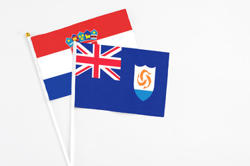 Fototapeta premium Anguilla and Croatia stick flags on white background. High quality fabric, miniature national flag. Peaceful global concept.White floor for copy space.