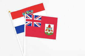 Fototapeta premium Bermuda and Croatia stick flags on white background. High quality fabric, miniature national flag. Peaceful global concept.White floor for copy space.