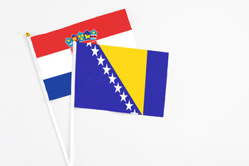 Bosnia Herzegovina and Croatia stick flags on white background. High quality fabric, miniature...