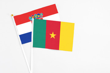 Cameroon and Croatia stick flags on white background. High quality fabric, miniature national flag. Peaceful global concept.White floor for copy space.