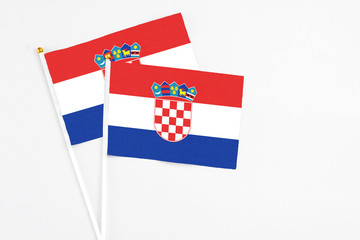 Croatia and Croatia stick flags on white background. High quality fabric, miniature national flag. Peaceful global concept.White floor for copy space.