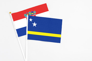 Curacao and Croatia stick flags on white background. High quality fabric, miniature national flag. Peaceful global concept.White floor for copy space.