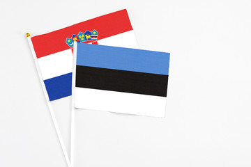 Estonia and Croatia stick flags on white background. High quality fabric, miniature national flag. Peaceful global concept.White floor for copy space.