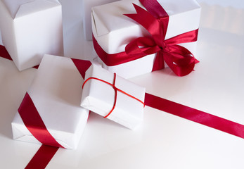 White and red christmas gifts, tied with red ribbons