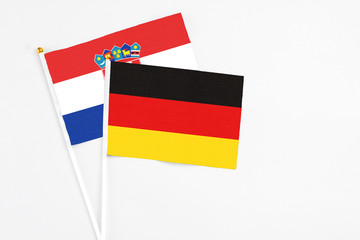 Germany and Croatia stick flags on white background. High quality fabric, miniature national flag. Peaceful global concept.White floor for copy space.